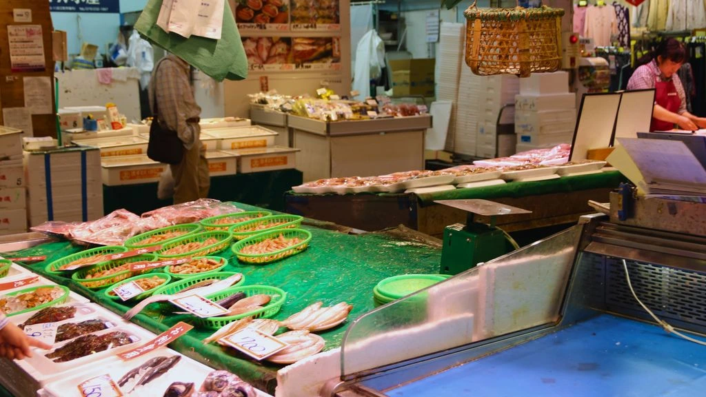 A Kanazawa morning market vendor arranging fresh wasabi leaves at first light.